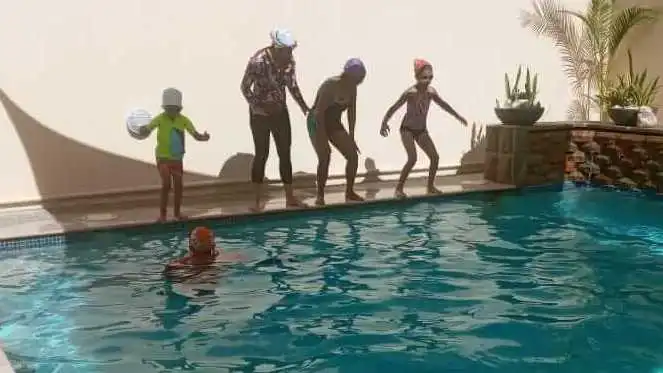 WAVE swimmers lined up on the pool edge with their coach